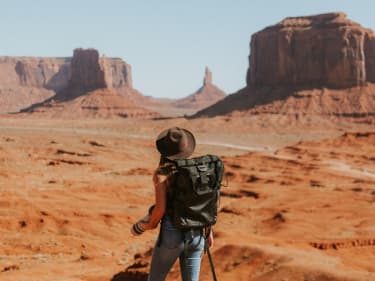 Traveler on brown hat staring across the horizon