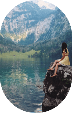 Woman sitting close to a cliff enjoying the view